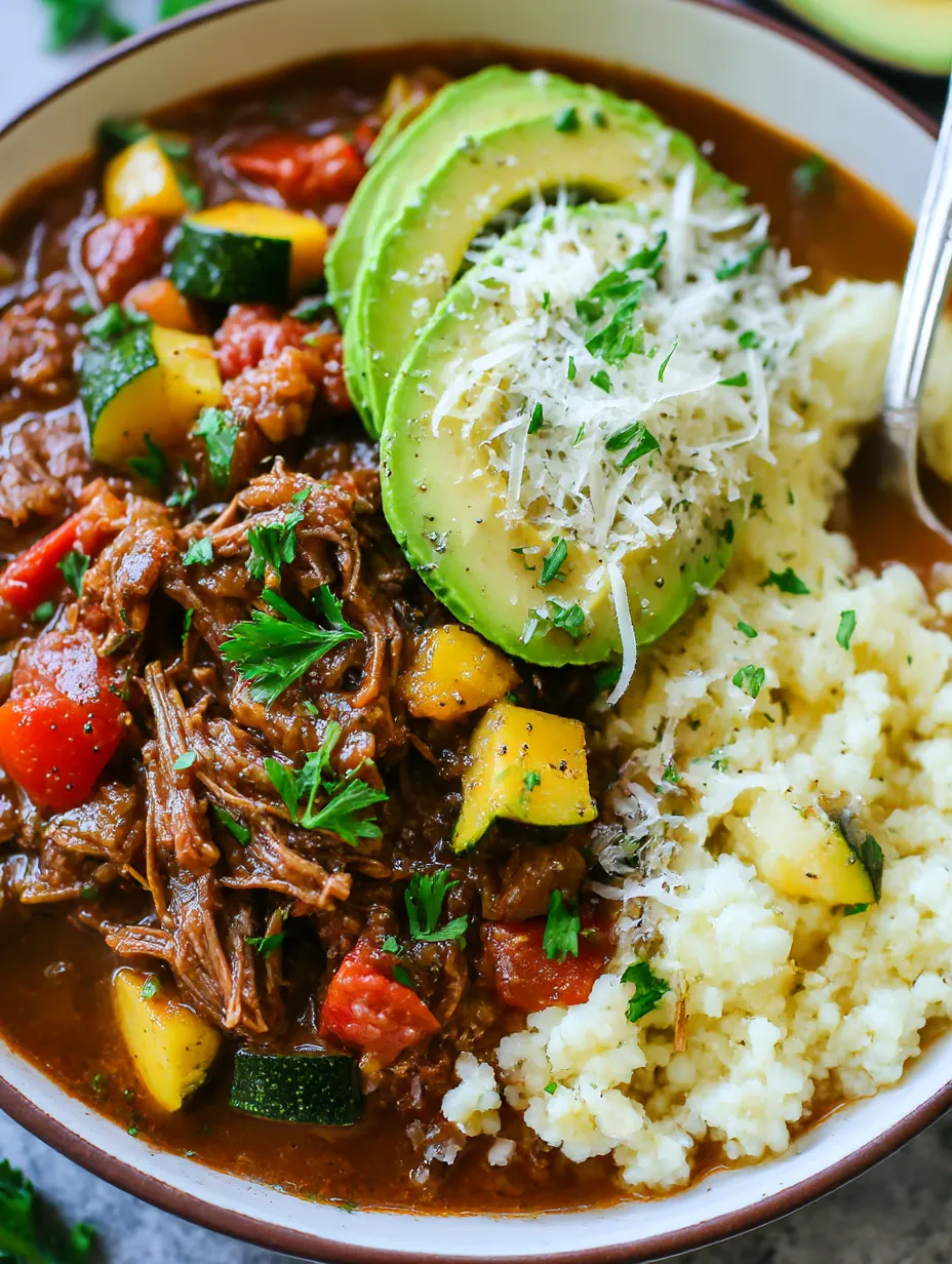A bowl of food with meat, potatoes, and vegetables.