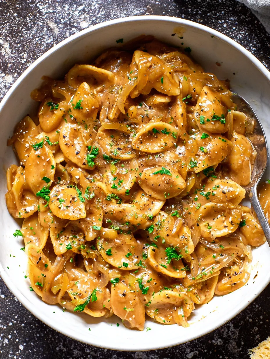 A bowl of pasta with a fork in it.