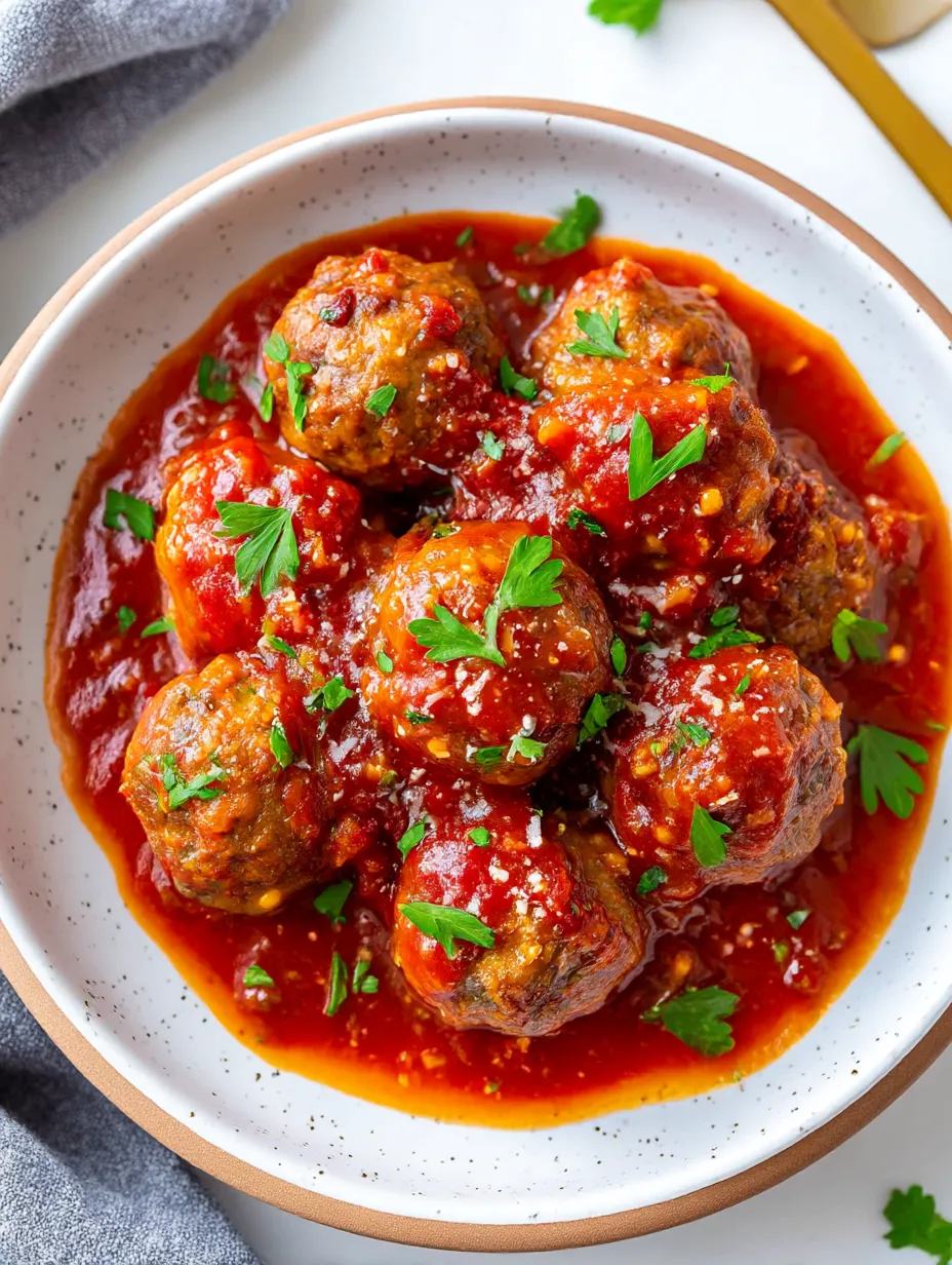 A bowl of meatballs in a red sauce.