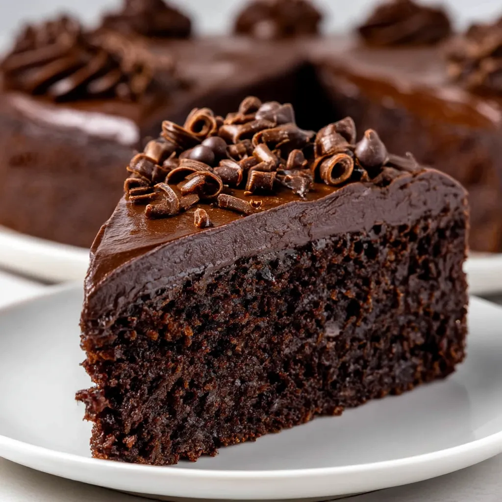 A slice of chocolate cake with chocolate chips on top.