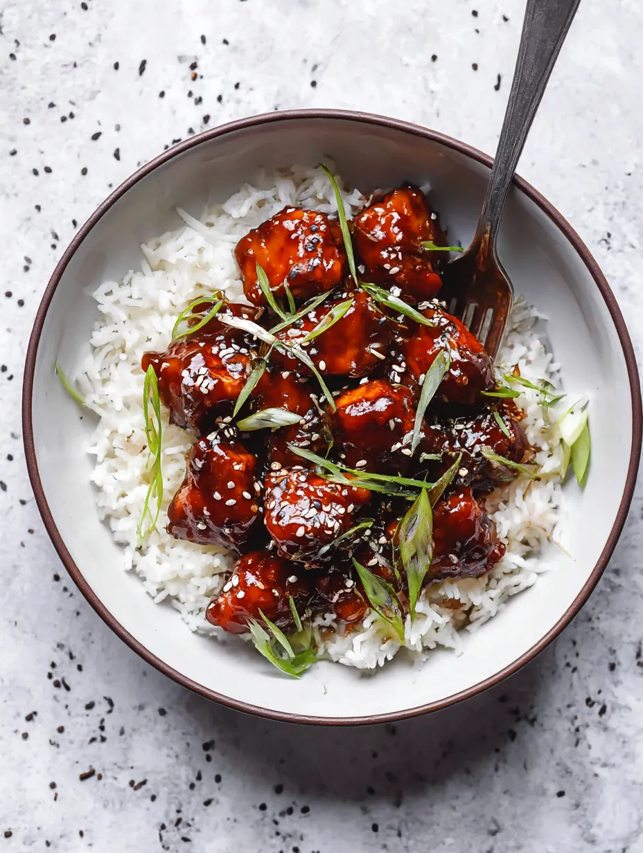 A plate of Korean BBQ chicken with rice.