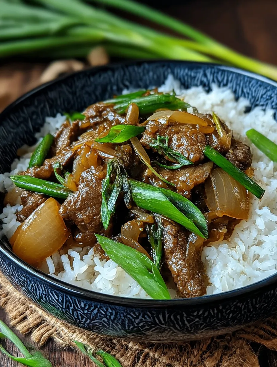 A bowl of Chinese beef and onion stir fry.
