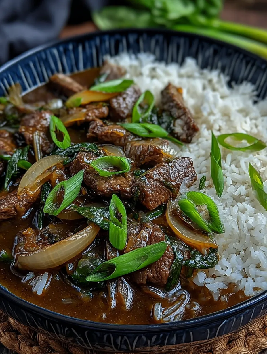 A bowl of Chinese beef and onion stir fry.